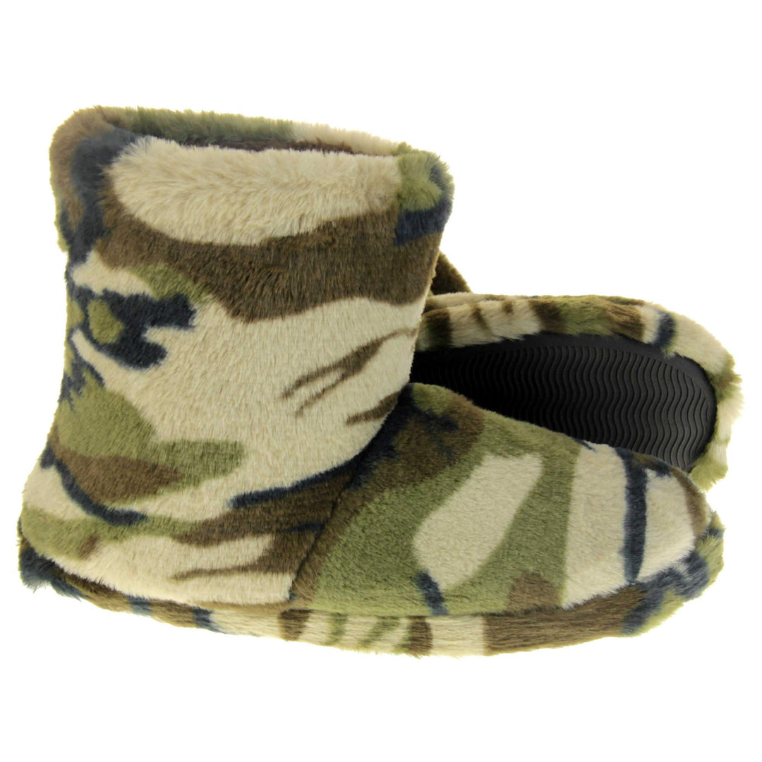 Camo slippers boots. Slipper boots with a camouflage army print faux fur upper. In khaki, brown, black and sand colours. With a firm black synthetic sole with grip to the base. Brown faux fur lining. Both feet from side profile with left foot on its side to show the sole.