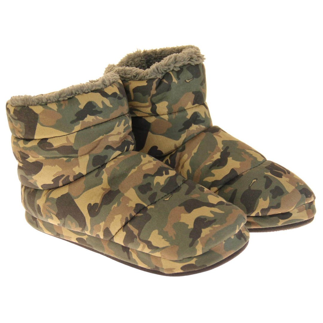 Camo slippers mens. Slipper boots with a camouflage army print textile upper. In khaki, brown, black and sand colours. With a firm black synthetic sole with grip to the base. Grey faux fur lining. Both feet together atr a slight angle.