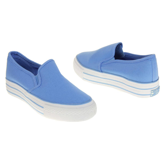 Canvas pumps. Slip on plimsoll style shoes with a blue canvas upper. Blue elasticated gusset. White flat platform sole with two blue lines running around the middle. Both feet at an angle facing top to tail.