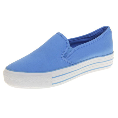 Canvas pumps. Slip on plimsoll style shoes with a blue canvas upper. Blue elasticated gusset. White flat platform sole with two blue lines running around the middle. Left foot at an angle.