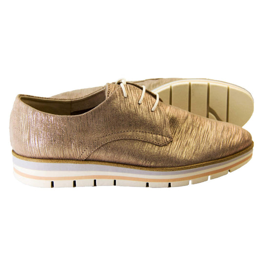 Casual oxfords. Womens oxford style shoes with a taupe metallic faux leather upper. Stitching detail to the sides. Cream laces and beige lining and cream, orange and lilac layered platform sole. Both feet from a side profile with the left foot on its side behind the the right foot to show the sole.