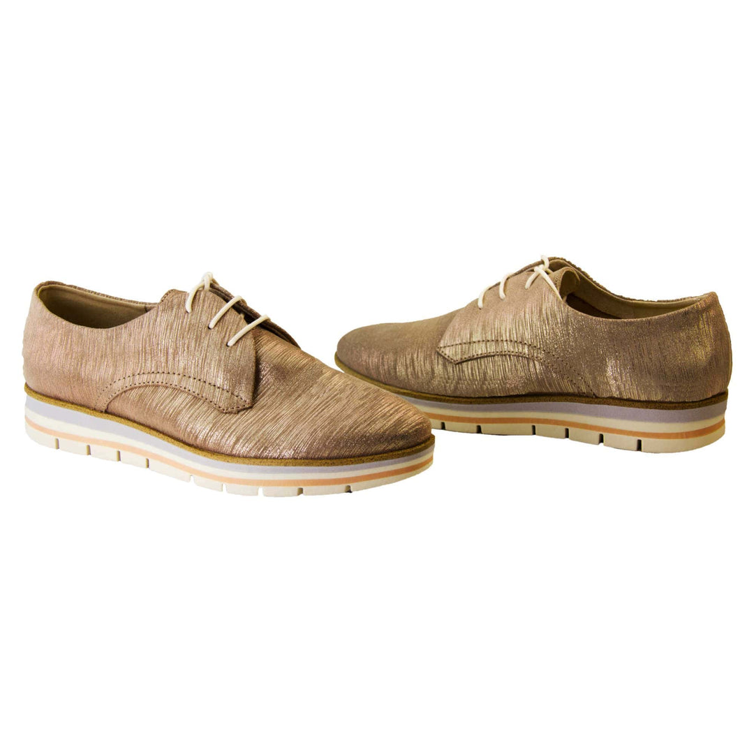 Casual oxfords. Womens oxford style shoes with a taupe metallic faux leather upper. Stitching detail to the sides. Cream laces and beige lining and cream, orange and lilac layered platform sole. Both feet at an angle facing top to tail.