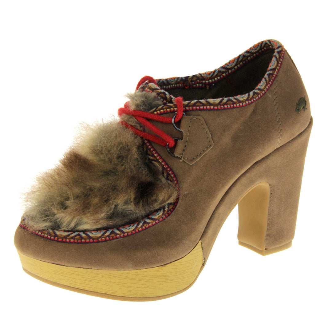 Chunky block heels. Womens bootie style shoe with a brown faux suede upper. Embroidered pattern around the collar and seams. Brown faux fur patch to the front and red laces. Rocket Dog logo to the heel of the bootie. Wood style platform to the front of the shoe with a chunky block heel in brown faux suede to the back. Nude sole. Left foot at an angle.