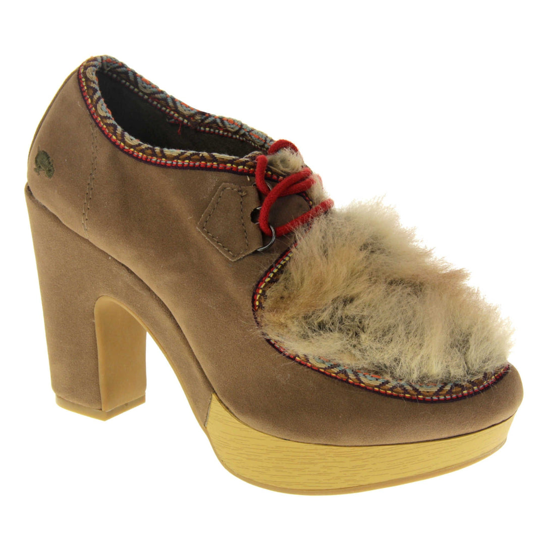 Chunky block heels. Womens bootie style shoe with a brown faux suede upper. Embroidered pattern around the collar and seams. Brown faux fur patch to the front and red laces. Rocket Dog logo to the heel of the bootie. Wood style platform to the front of the shoe with a chunky block heel in brown faux suede to the back. Nude sole. Right foot at an angle.
