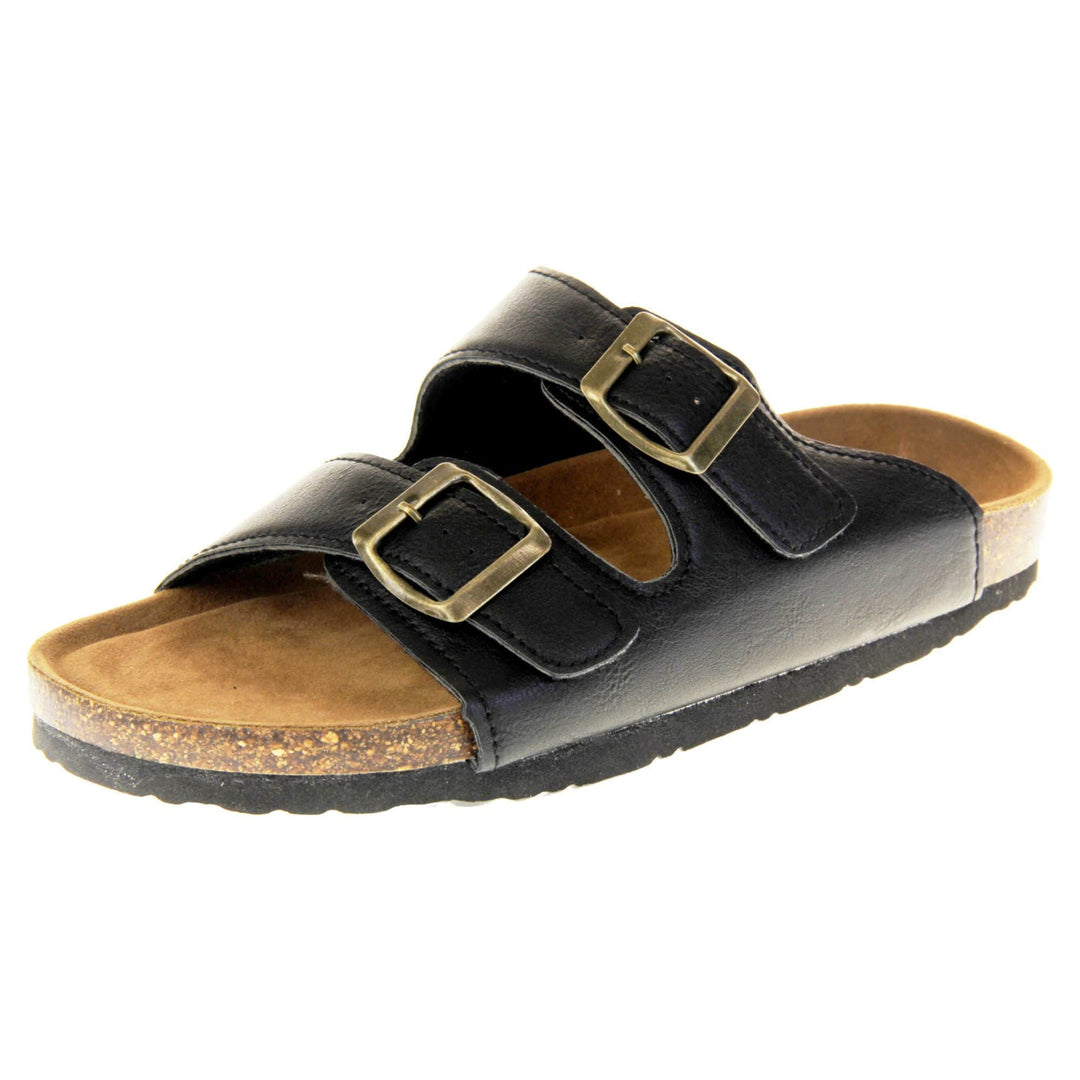 Classic black sandals. Womens dual strap slip on sandals. With a black synthetic leather upper with a gold buckle on each strap. Brown faux suede insole with a moulded footbed. Cork effect outsole with black base with grip to the bottom. Left foot at an angle.