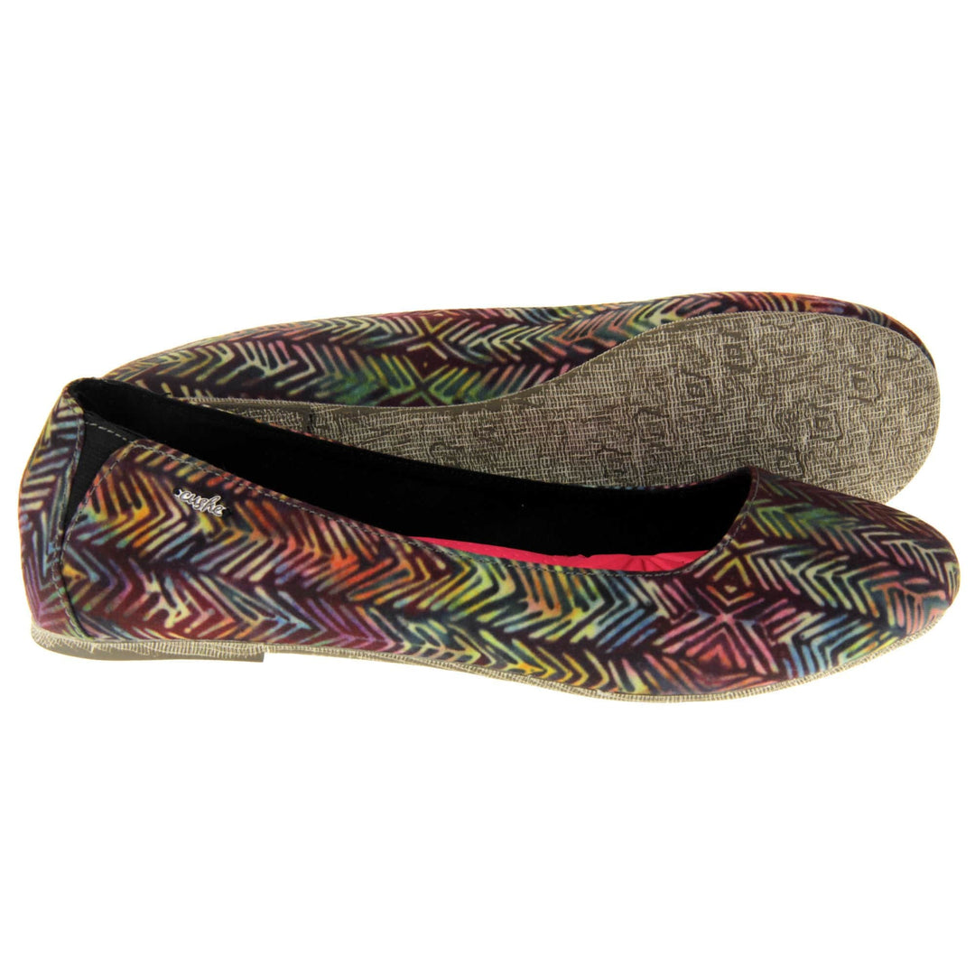 Comfort ballet flats. Women's ballerina shoes with a textile upper in a colourful herringbone style. Black textile lining with neon pink cushioned insole.  Both feet from a side profile with the left foot on its side behind the the right foot to show the sole.