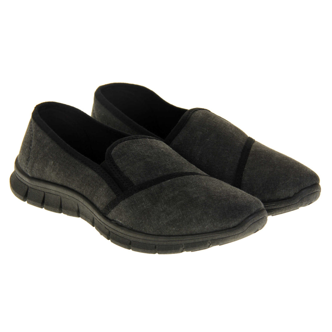 Comfortable black work shoes. Slip on plimsoll style shoes with a black canvas upper. Black elasticated gusset. Chunky black sole. Both feet together at a slight angle.