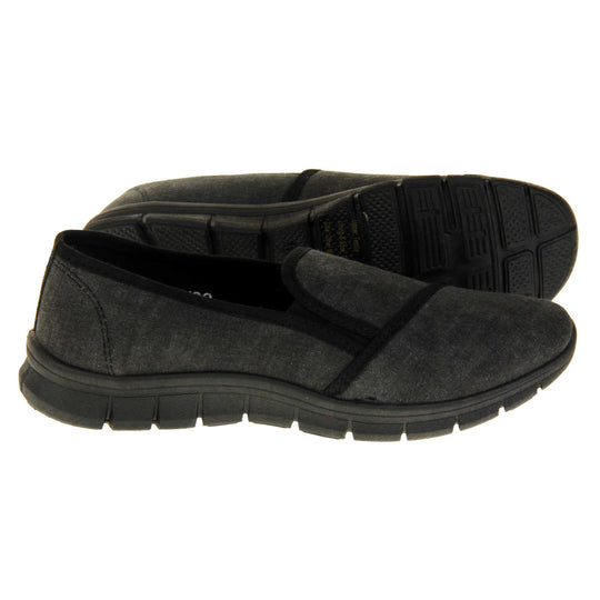 Comfortable black work shoes. Slip on plimsoll style shoes with a black canvas upper. Black elasticated gusset. Chunky black sole.  Both feet from a side profile with the left foot on its side behind the the right foot to show the sole.