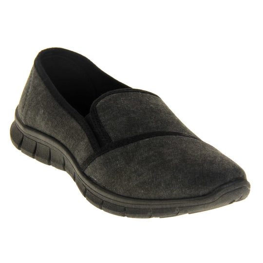 Comfortable black work shoes. Slip on plimsoll style shoes with a black canvas upper. Black elasticated gusset. Chunky black sole. Right foot at an angle.