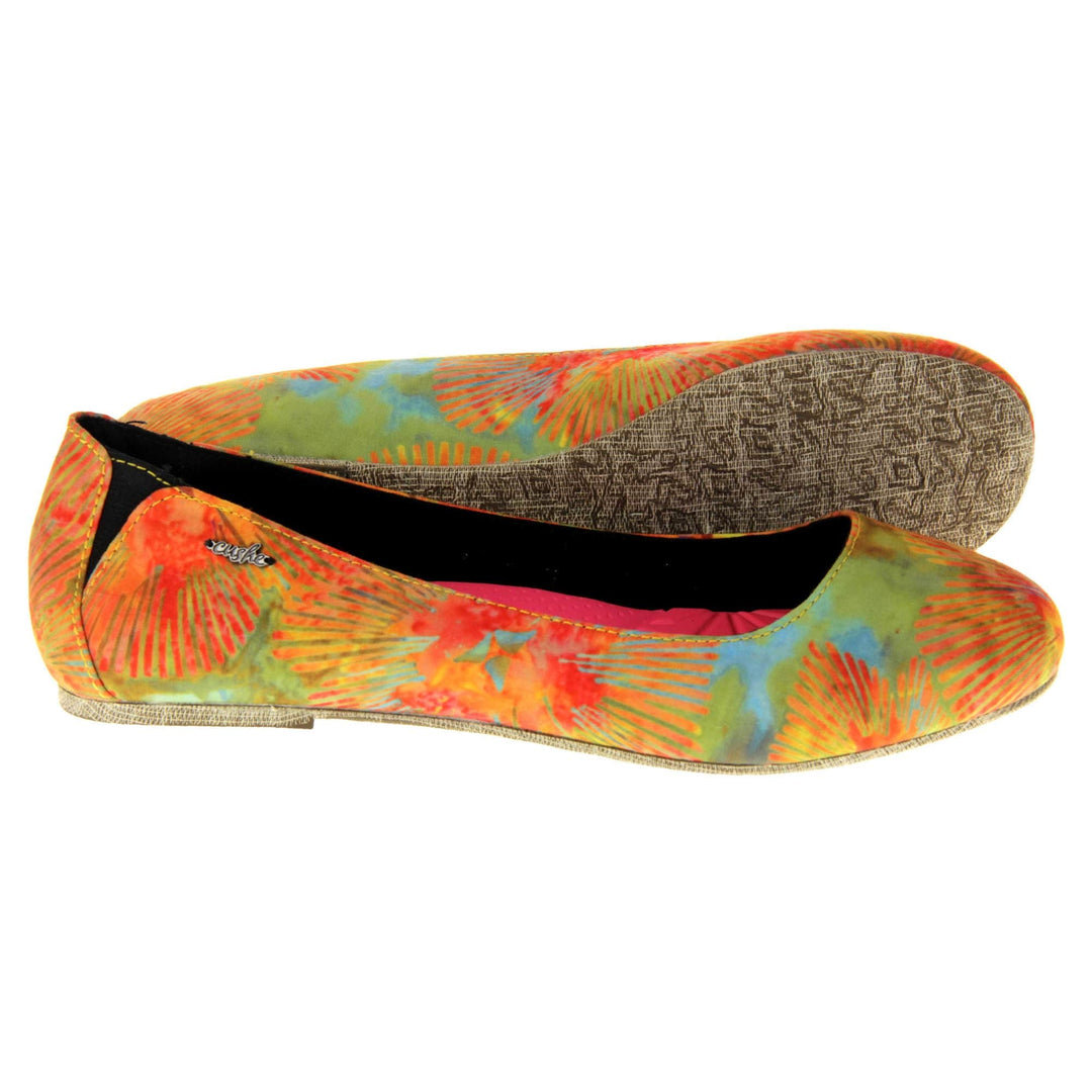 Comfy ballet flats. Women's ballerina shoes with a textile upper in a bright tie dye style. Black textile lining with neon pink cushioned insole. Both feet from a side profile with the left foot on its side behind the the right foot to show the sole.