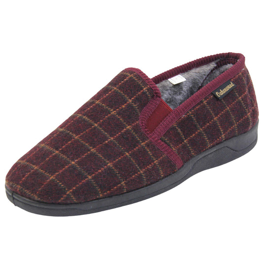 Comfy mens slippers. Full back slippers with burgundy wool effect upper with orange check. Red elasticated panels joining the tongue to the top of the slippers. Small black label on the outside rim, with Oakenwood branding sewn in gold. Grey faux fur lining. Left foot at an angle.