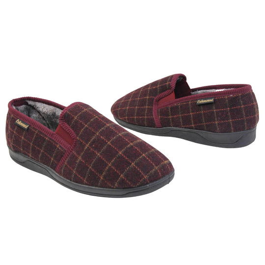 Comfy mens slippers. Full back slippers with burgundy wool effect upper with orange check. Red elasticated panels joining the tongue to the top of the slippers. Small black label on the outside rim, with Oakenwood branding sewn in gold. Grey faux fur lining. Both feet facing top to tail, at an angle.
