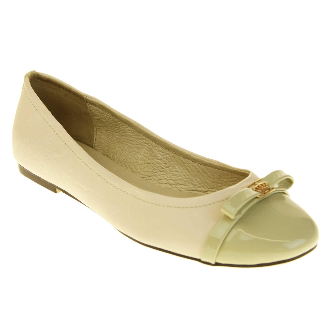Cream ballet flats. Cream leather ballet pumps with pale green patent toe and bow detail. Pale green patent stripe down the heel of the upper. Beige outsole with black rim and with a very slight heel. Right foot at an angle.