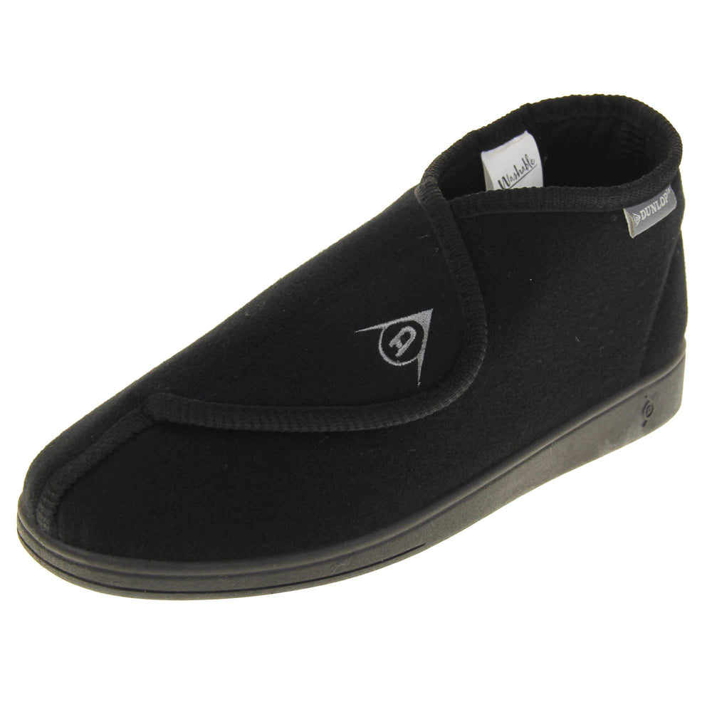 Orthopaedic slipper boots. Mens orthopaedic slippers in an ankle boot style. With a soft black textile upper and black textile lining. With an adjustable touch close top with a grey Dunlop logo on. Small grey label to the outer side edge with Dunlop written on. Thick black outdoor sole. Left foot at an angle.
