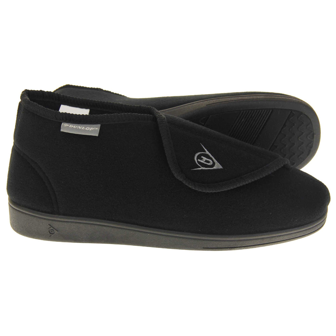 Orthopaedic slipper boots. Mens orthopaedic slippers in an ankle boot style. With a soft black textile upper and black textile lining. With an adjustable touch close top with a grey Dunlop logo on. Small grey label to the outer side edge with Dunlop written on. Thick black outdoor sole. Both feet from side profile with the left foot on its side to show the sole
