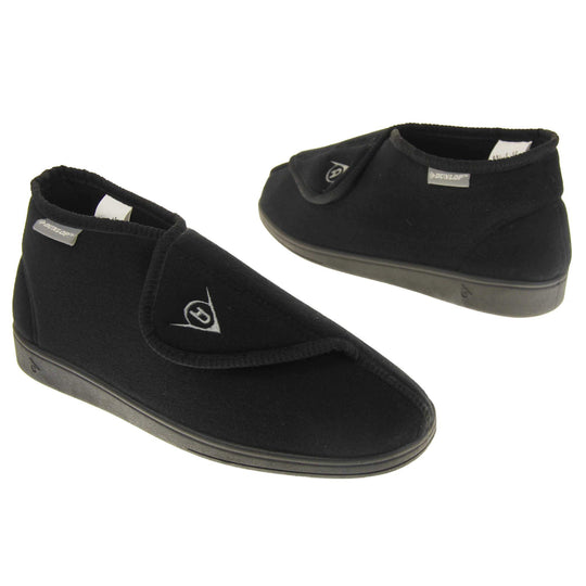 Orthopaedic slipper boots. Mens orthopaedic slippers in an ankle boot style. With a soft black textile upper and black textile lining. With an adjustable touch close top with a grey Dunlop logo on. Small grey label to the outer side edge with Dunlop written on. Thick black outdoor sole. Both feet at a slight angle facing top to tail.