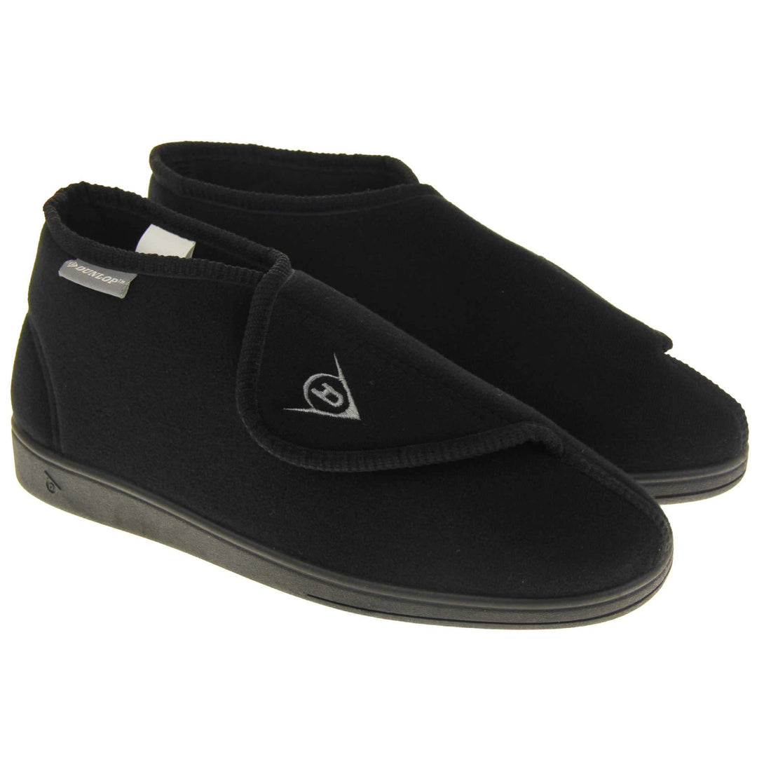 Orthopaedic slipper boots. Mens orthopaedic slippers in an ankle boot style. With a soft black textile upper and black textile lining. With an adjustable touch close top with a grey Dunlop logo on. Small grey label to the outer side edge with Dunlop written on. Thick black outdoor sole. Both feet together at an angle