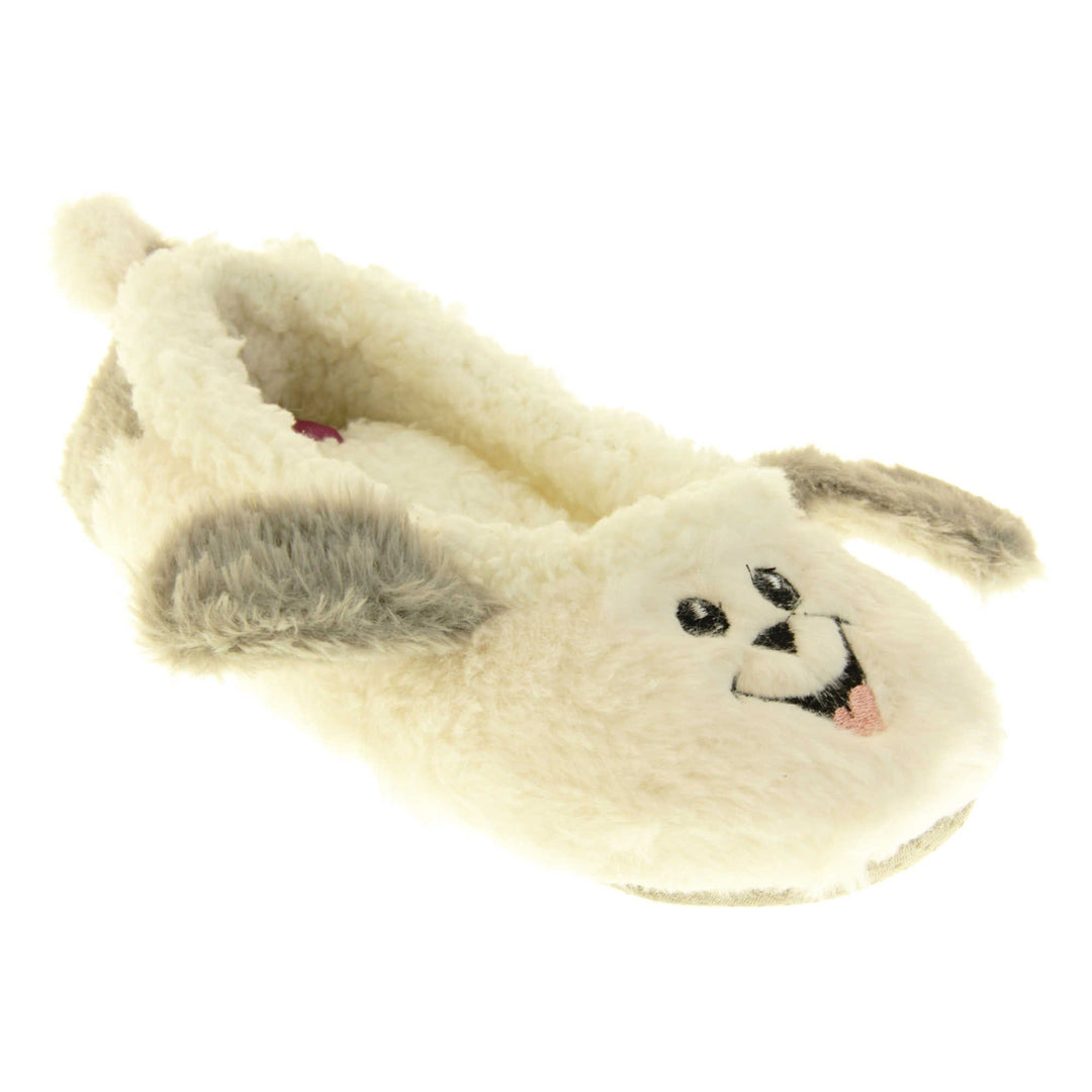 Dog slippers womens. Ladies slippers in a ballerina style. With white faux fur upper, cute embroidered sheepdog face and grey floppy ears. White faux fur lining. Beige textile sole with bumps to the bottom for grip. Right foot at an angle.