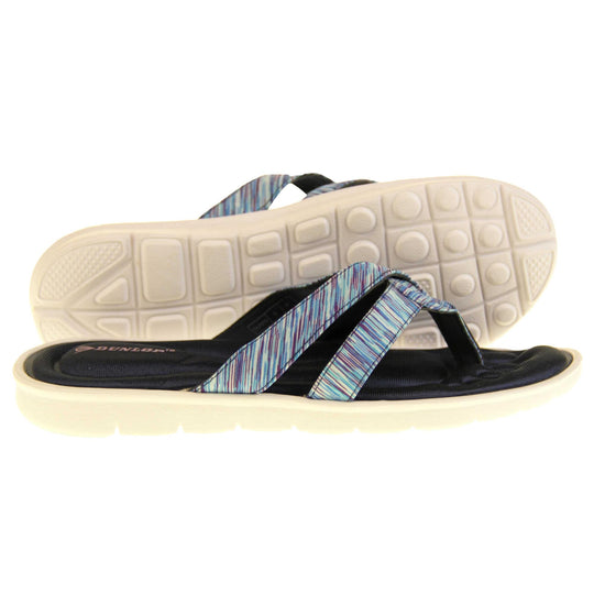 Dunlop flip flops. Womens flip flops with two straps done in a purple, teal and blue textile material meeting at a toe post. Black moulded, cushioned insole with white sole. Both feet from a side profile with the left foot on its side behind the the right foot to show the sole.