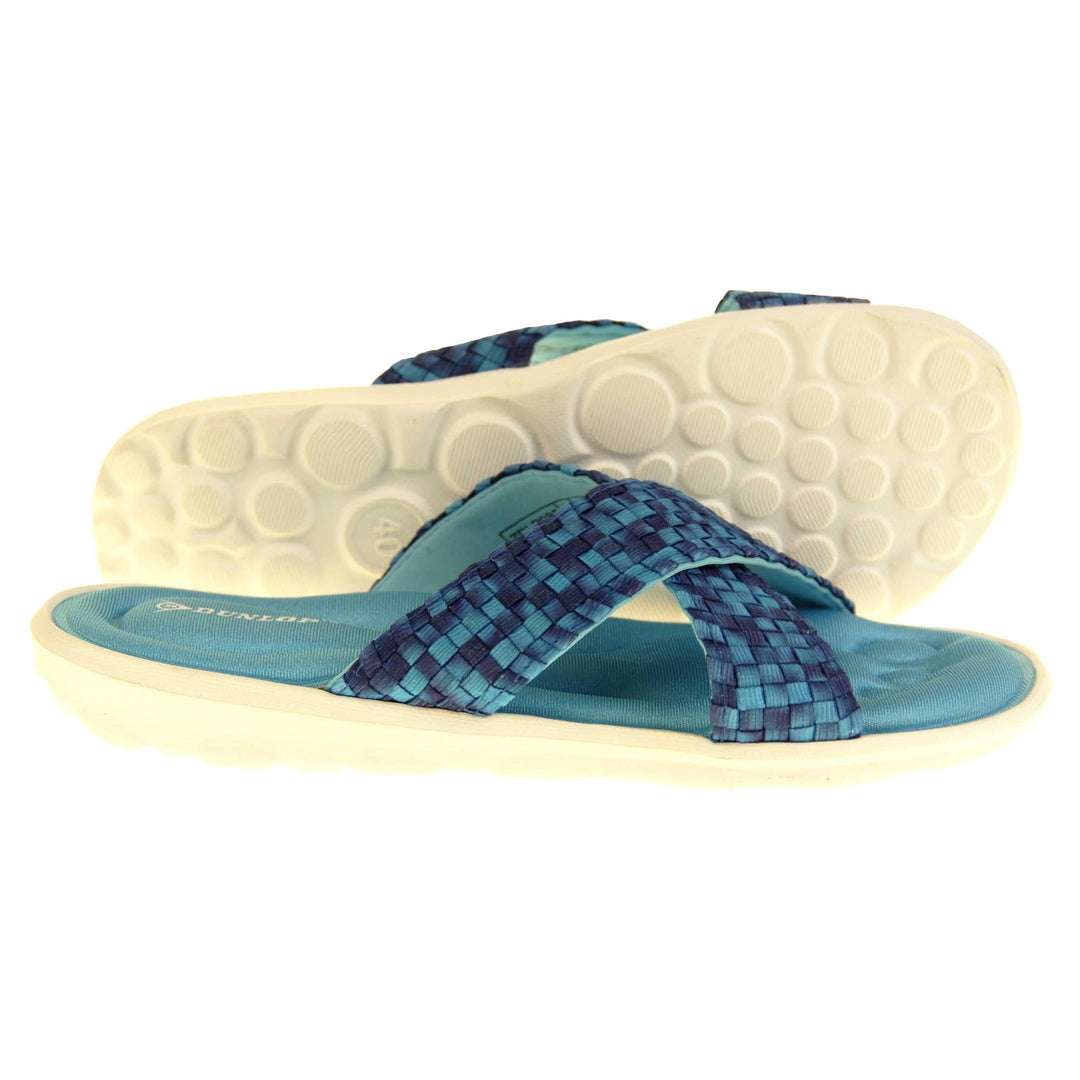 Womens slide sandals - Royal blue mosaic style straps in crossover design with dense memory foam insoles - perfect comfy sandals for women. Quick and easy slip on flip flops with light blue insole and white outsole with a slight wedge heel. Right foot side on and left foot tilted showing circular grips to white outsole.