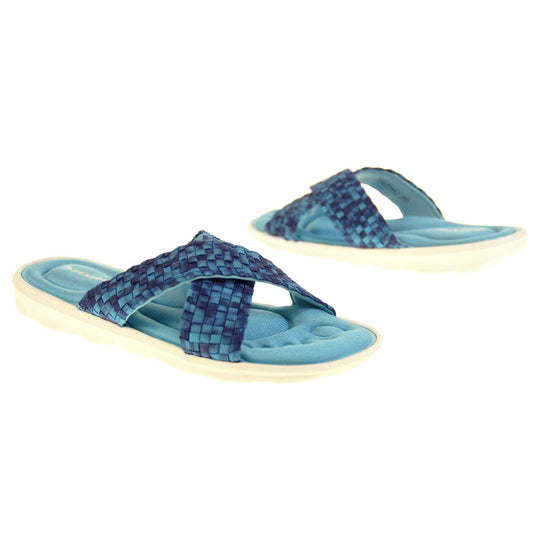 Womens slide sandals - Royal blue mosaic style straps in crossover design with dense memory foam insoles - perfect comfy sandals for women. Quick and easy slip on flip flops with light blue insole and white outsole with a slight wedge heel. Both feet at different angles.