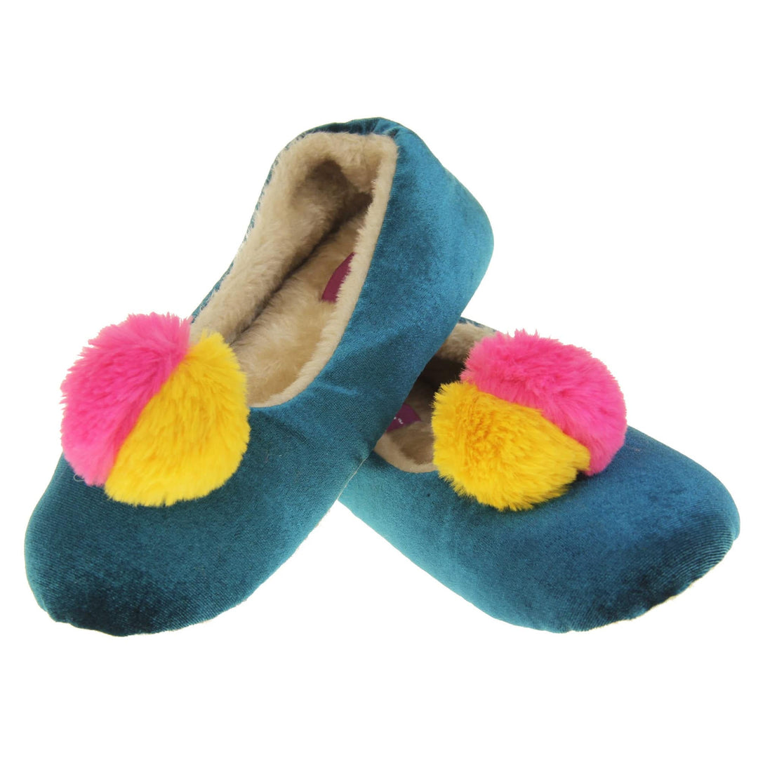 Womens ballet slippers. Ladies slippers in a ballerina style. Teal velvety upper with fluffy yellow and pink pom pom on the top. Cream faux fur lining. Beige textile sole with bumps to the bottom for grip. Both shoes in a V shape with the back of the right shoe on top of the back of the left.