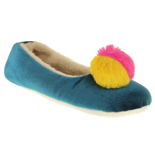 Womens ballet slippers. Ladies slippers in a ballerina style. Teal velvety upper with fluffy yellow and pink pom pom on the top. Cream faux fur lining. Beige textile sole with bumps to the bottom for grip. Right foot at an angle.