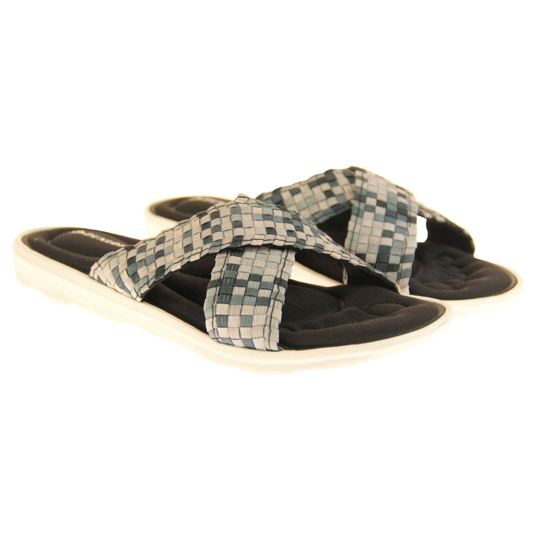 Womens black flat sandals - Black and grey mosaic style crossover straps with a dense black memory foam insole - perfect comfy sandals for women. White outsole. Both feet together at an angle.