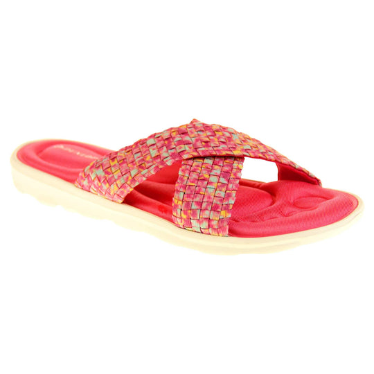 Pink sandals for women - Hot pink mosaic style crossover sandals with memory foam insole, white low heel flat outsole in a flip flop design. Right foot at an angle.