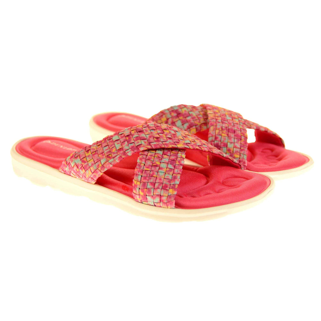 Pink sandals for women - Hot pink mosaic style crossover sandals with memory foam insole, white low heel flat outsole in a flip flop design. Both feet at an angle.