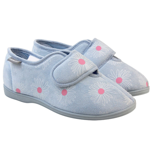 Slippers for swollen feet. Womens full back slipper. With a pale blue upper with white daisy design with bright pink for the middle of the flowers. Touch fasten strap over the top of the foot to adjust the fit. Matching blue textile lining and sole. Both feet together at angle.