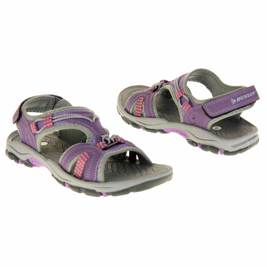Womens Dunlop Hiking Sandals - Plum purple faux leather upper with light purple mesh and grey elasticated strap detailing around. Good grips to the sole and a hook and loop ankle strap for a secure fit. Grey, purple and black flexible outsole. Both feet facing different directions.