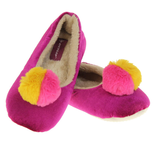 Womens ballet slippers. Ladies slippers in a ballerina style. Fuchsia velvety upper with fluffy yellow and pink pom pom on the top. Cream faux fur lining. Beige textile sole with bumps to the bottom for grip. Both shoes in a V shape with the back of the right shoe on top of the back of the left.