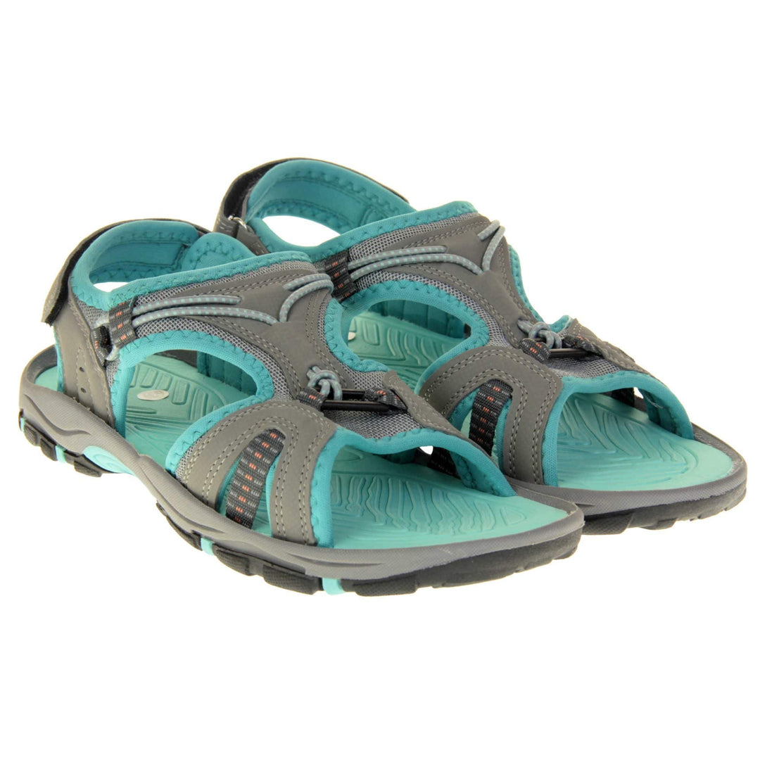 Dunlop womens walking sandals - Light grey faux leather upper with decorative elasticated strap detailing and teal blue trim. Hook and loop touch fastening ankle strap for secure fitting. Turquoise padded insole for extra comfort and a teal, grey and black flexible outsole with good grips for hiking. Both feet together.