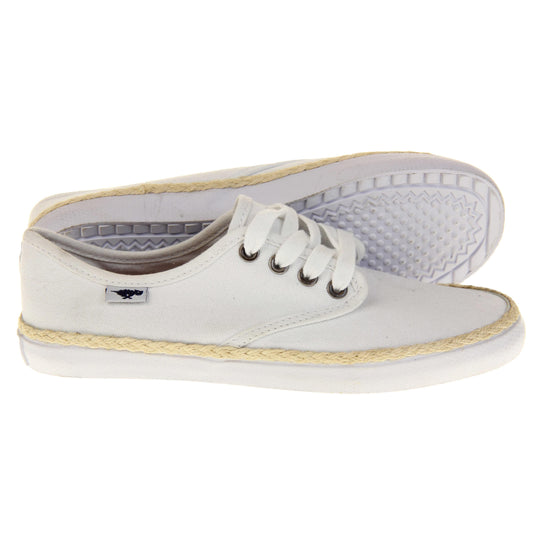 Espadrille pumps. Sneaker style shoes with a white canvas upper. White laces and a small Rocket Dog label to the side. White outsole with espadrille rope around the top. Both feet from a side profile with the left foot on its side behind the the right foot to show the sole.