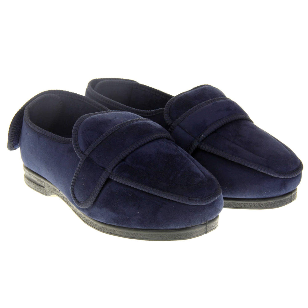 Extra wide fit slippers for men. Full back slippers with navy blue upper. Adjustable touch fasten strap to the top of the foot and around the back of the heel. Navy textile lining. Firm black sole. Both feet together at an angle.
