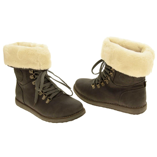 Faux fur lined winter boot. Women's boot in an ankle style with a grey faux suede upper. Pull on design with grey faux laces detail to the front. Cream faux fur lining and collar. Grey sole with grip to the bottom. Both feet from a slight angle facing top to tail.