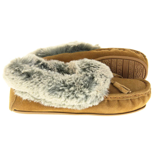Faux fur moccasin slippers. Womens brown faux suede moccasin style slippers. With stitched detailing and tassels with subtle glitter on. Pale grey faux fur collar and lining. Brown firm sole. Both feet from a side profile with the left foot on its side behind the the right foot to show the sole.