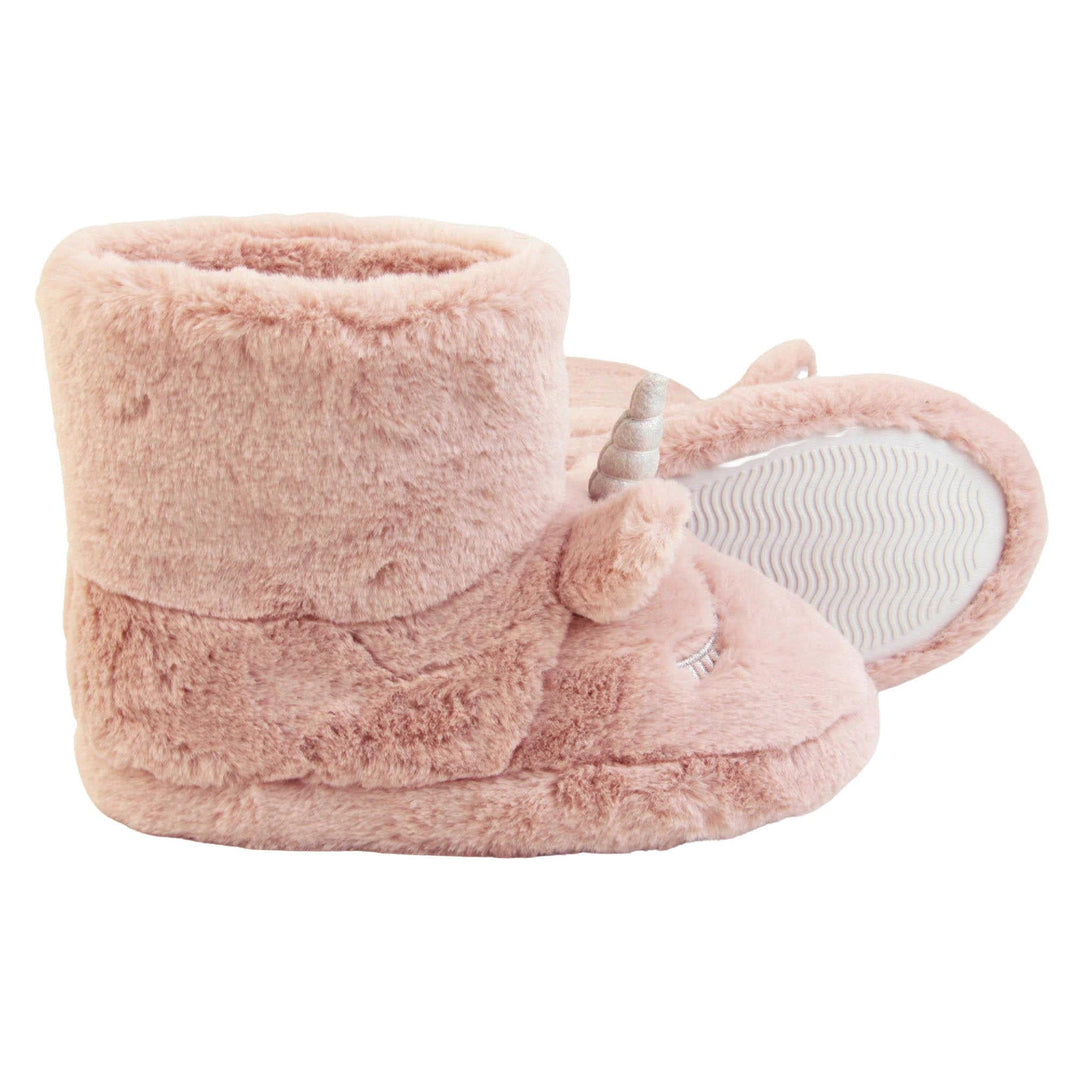 Faux fur slipper boots. Furry slipper boots in pink with a cute unicorn face on. With glittery ears and horn. The same colour faux fur lines the boot. Both feet from a side profile with left foot on its side to show the sole.