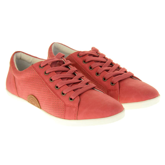 Faux suede sneakers. Women's shoes in a sneaker trainer style with a red faux suede upper. Tiny dot cut-out detailing to the side of the shoe. Red laces and a brown half-circle to the side of the shoe with Keddo branding on it. White leather lining and sole. Both feet together at a slight angle.
