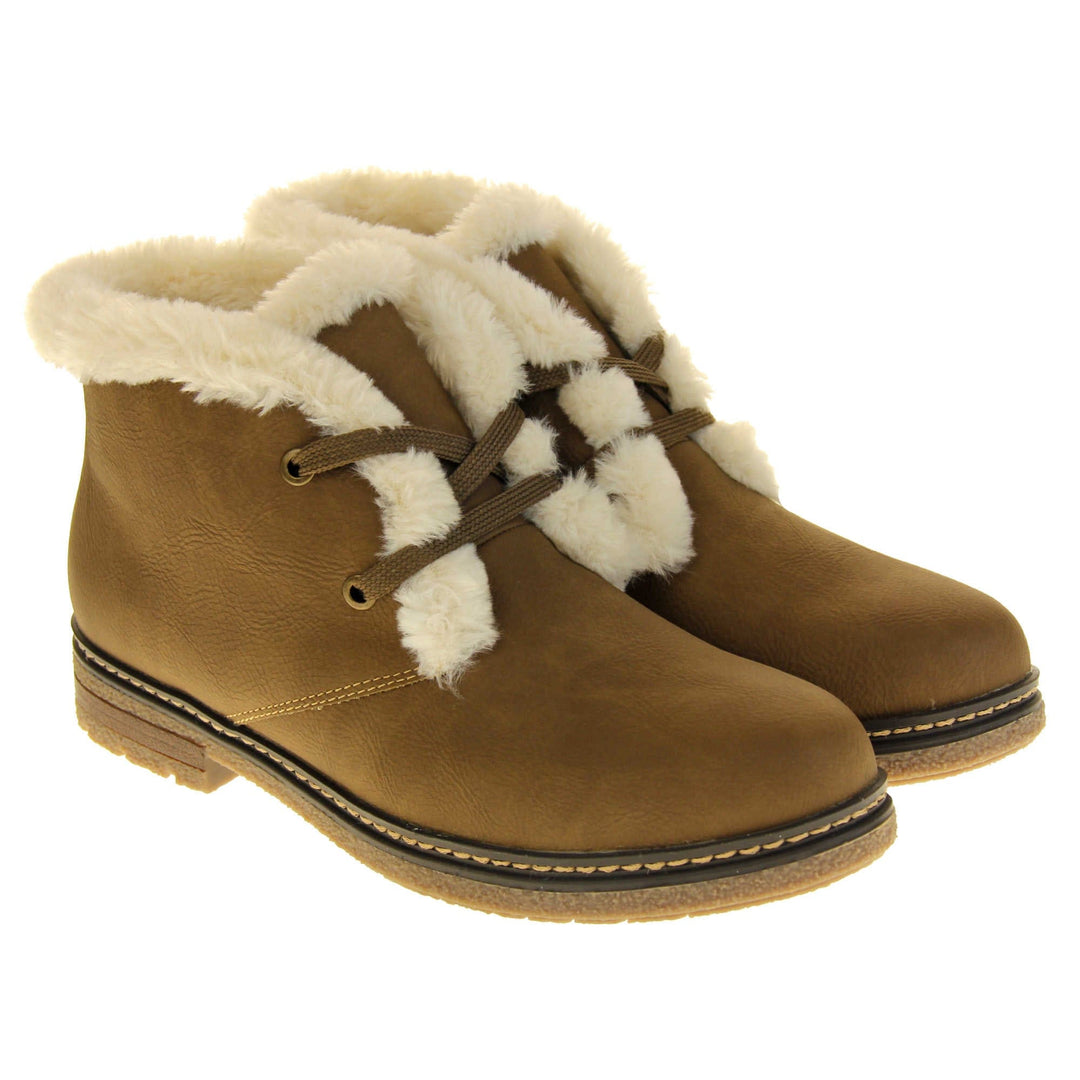 Fleece lined ankle boots. Women's ankle boots in a lace up style with a brown faux nubuck upperFleece lined ankle boots. Women's ankle boots in a lace up style with a brown faux nubuck leather upper. Brown laces with gold colopured eyelets. Cream faux fur trim and lining. Brown sole with grippy base. Both feet together from an angle.