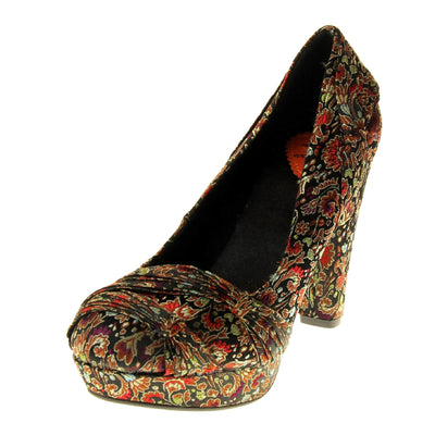 Floral block heels. Womens high heels with a floral textile upper. Ruched detailing to the front. Black textile lining with a red circle on the insole with black Rocket Dog logo. Small platform on the front of the outsole with a chunky block heel to the back covered in the same textile as the upper. Black sole to the bottom. Left foot at an angle.
