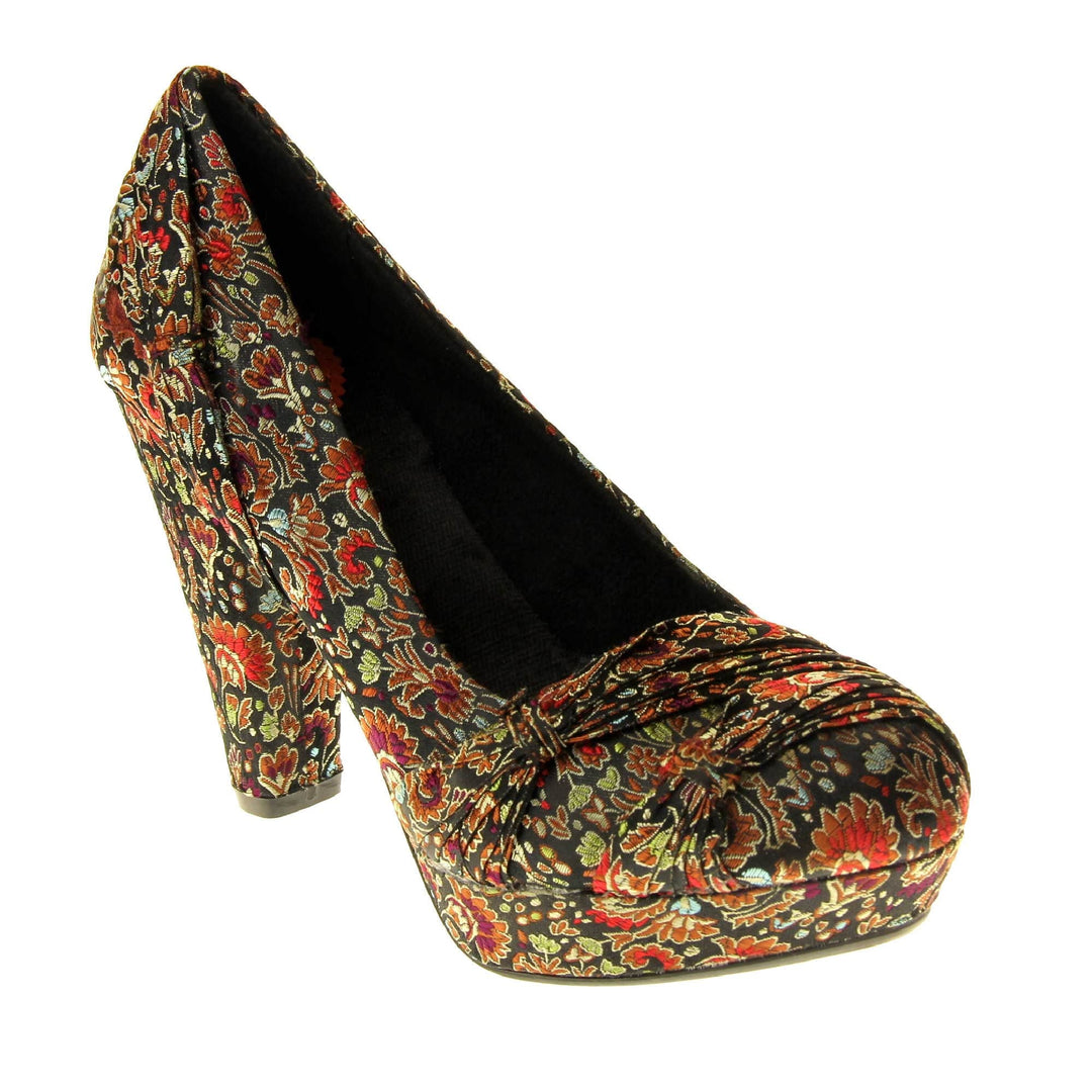 Floral block heels. Womens high heels with a floral textile upper. Ruched detailing to the front. Black textile lining with a red circle on the insole with black Rocket Dog logo. Small platform on the front of the outsole with a chunky block heel to the back covered in the same textile as the upper. Black sole to the bottom. Right foot at an angle.