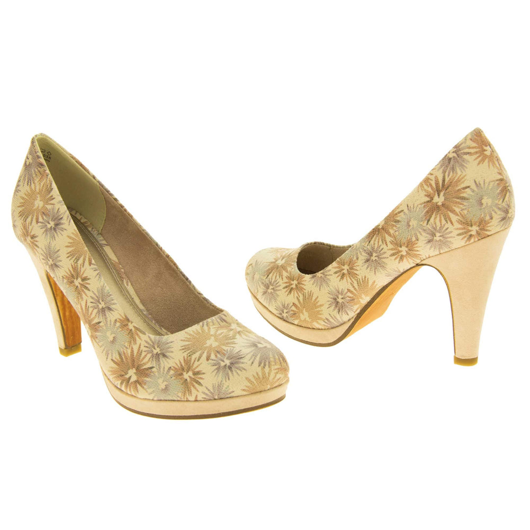 Floral heels. Womens court shoes with a cream upper with faded floral multi coloured pattern. Matching insole with Marco Tozzi branding. Taupe faux suede lining. Small cream platform and mid stiletto heel. Brown sole. Both feet at an angle facing top to tail.