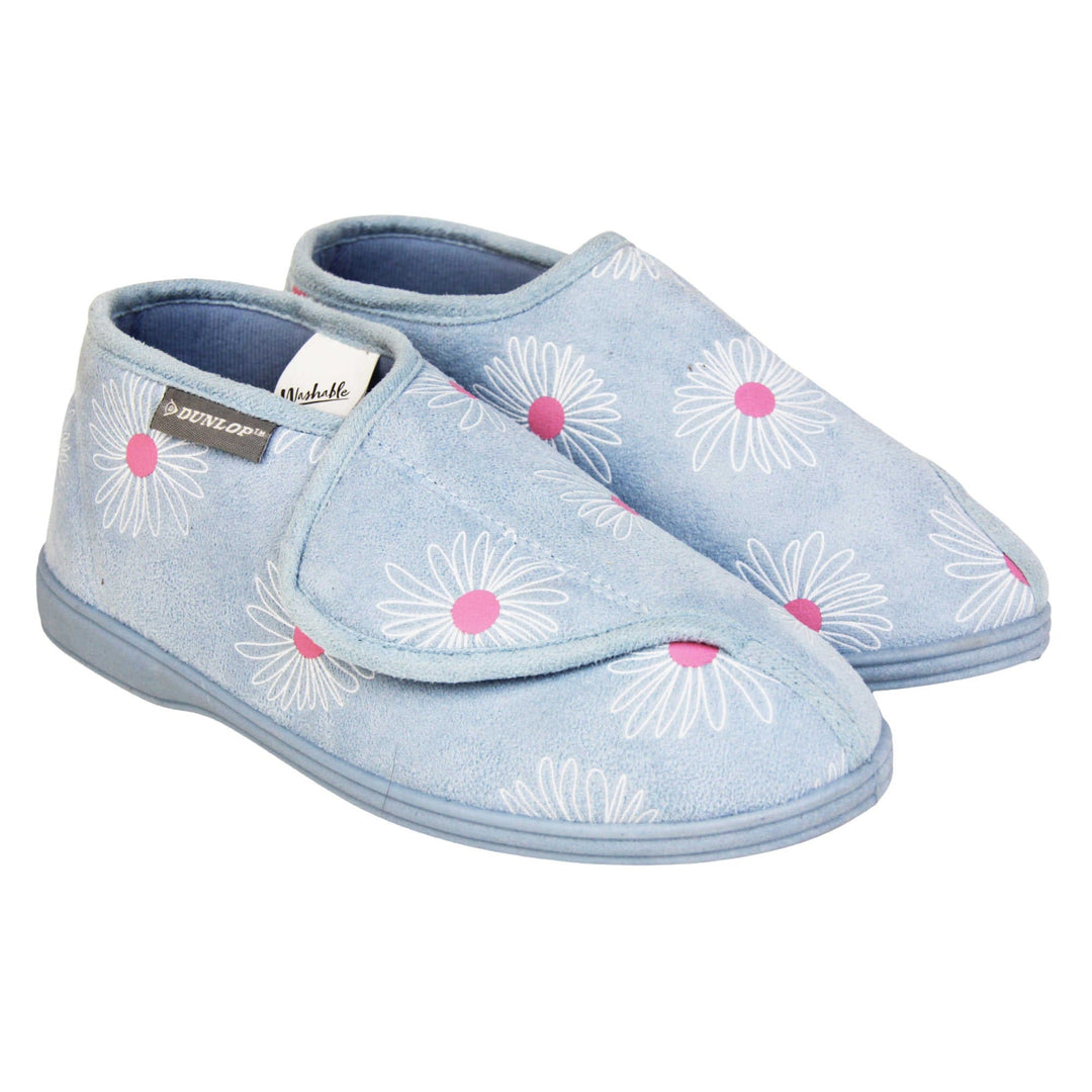 Flower slippers. Womens bootie style slipper with a pale blue textile upper with a white and pink flower print. Touch fasten tab to the top and blue textile lining. Firm blue sole. Both feet together at angle.