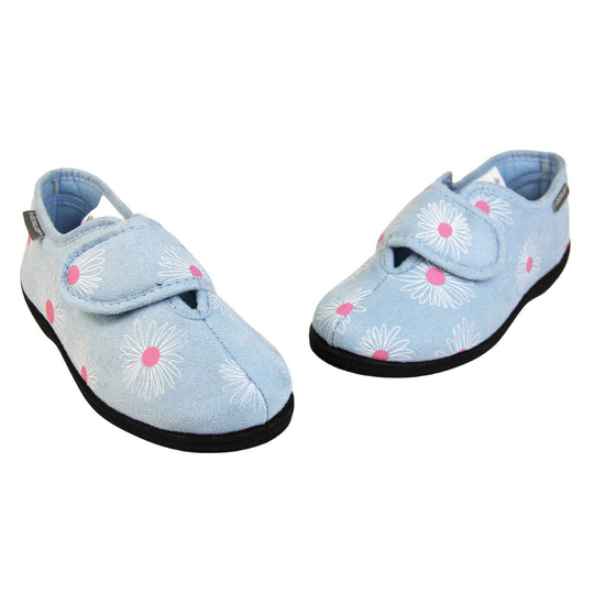 Flower slippers. Womens full back slipper. Pale blue upper with white daisy design and bright pink for the middle of the flowers. Touch fasten strap over the top of the foot to adjust the fit. Matching blue textile lining and firm black sole. Both feet in a V shape with toes almost touching.