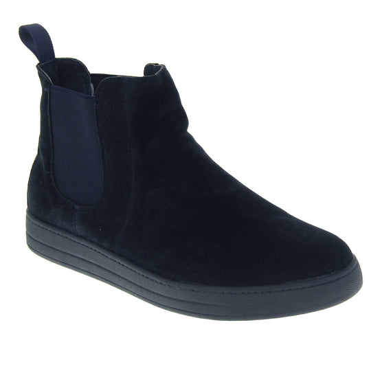Fur lined Chelsea boots. Women's ankle boot with a navy blue suede upper. Navy elasticated panels at the ankles and navy faux fur lining. A navy loop at the heel to help pull them on. Black outsole. Right foot at an angle.