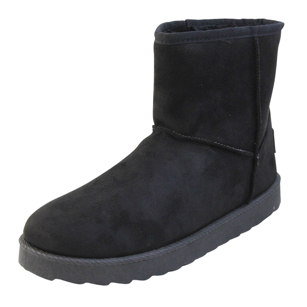 Fur lined winter boots. Ankle boots with a black faux suede upper and stitching detail. Black faux fur lining. Chunky black sole with deep tread to the bottom. Left foot at an angle.
