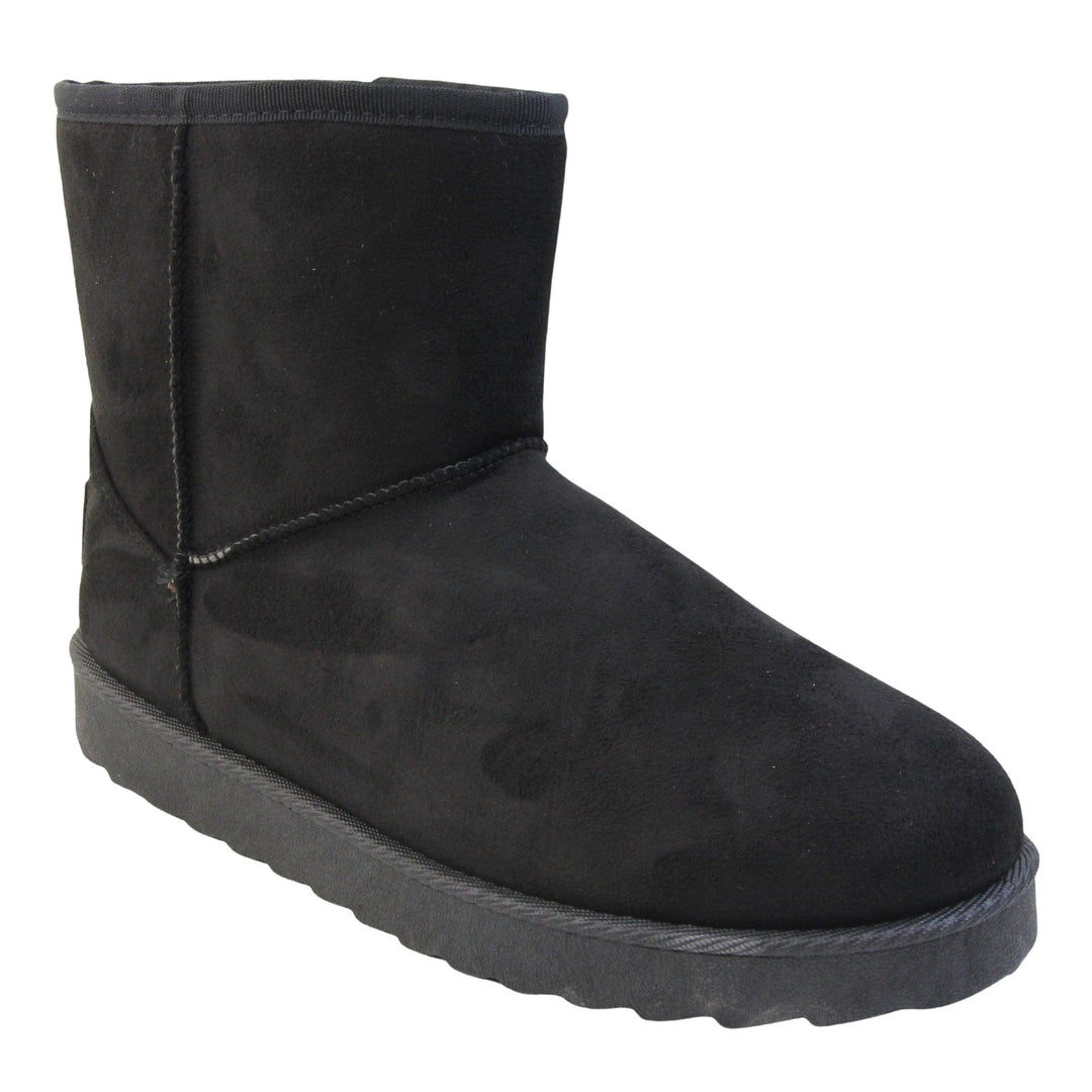 Fur lined winter boots. Ankle boots with a black faux suede upper and stitching detail. Black faux fur lining. Chunky black sole with deep tread to the bottom. Right foot at an angle.