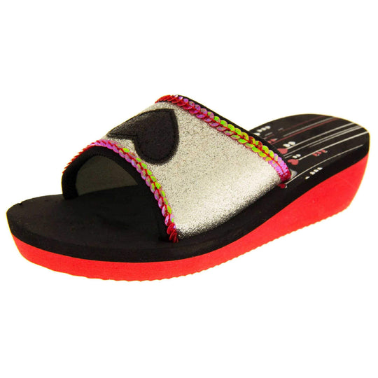 Foam wedge sandals for girls. Red bottom half of the sole with ridges for grip, black top half with red and white heart and line design to the heel of the insole. Silver glitter full strap with black glitter heart in the middle and pink sequins along the edges. Left foot at an angle.
